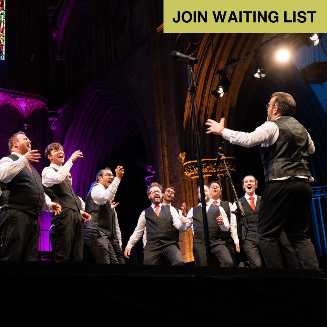A male choir stand on stage in Lichfeld Cathedral