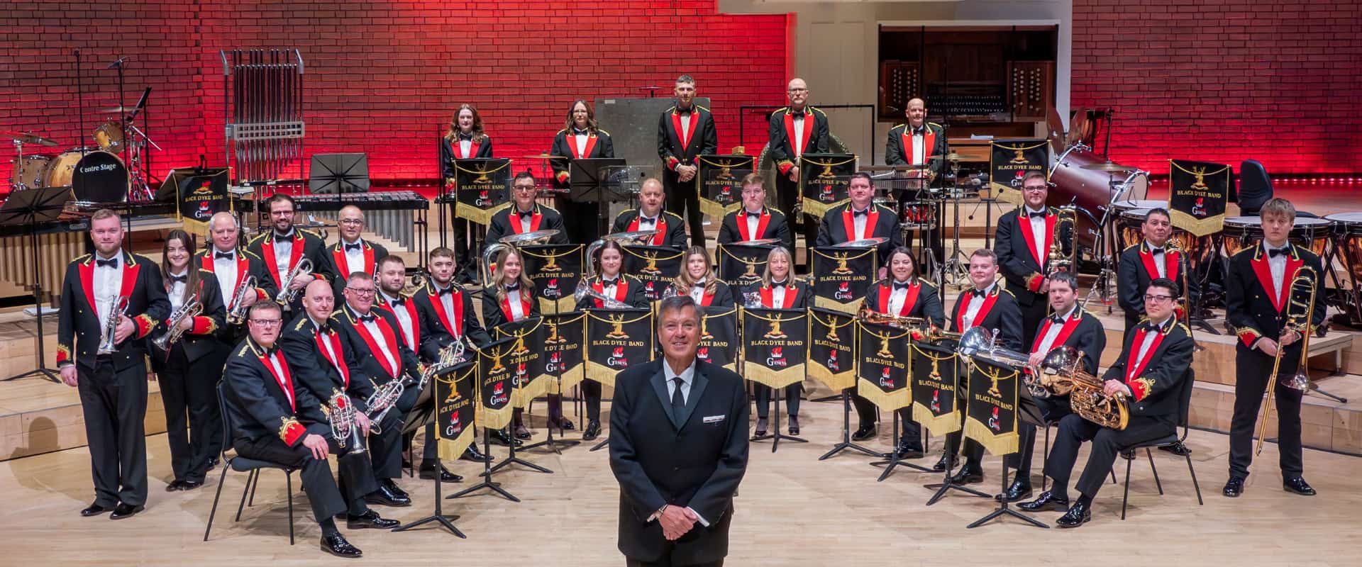 A brass band stand in a horseshoe for a photo