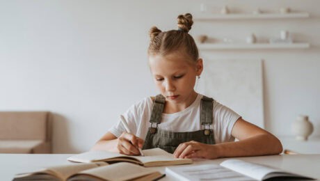 Young girl writing in a book
