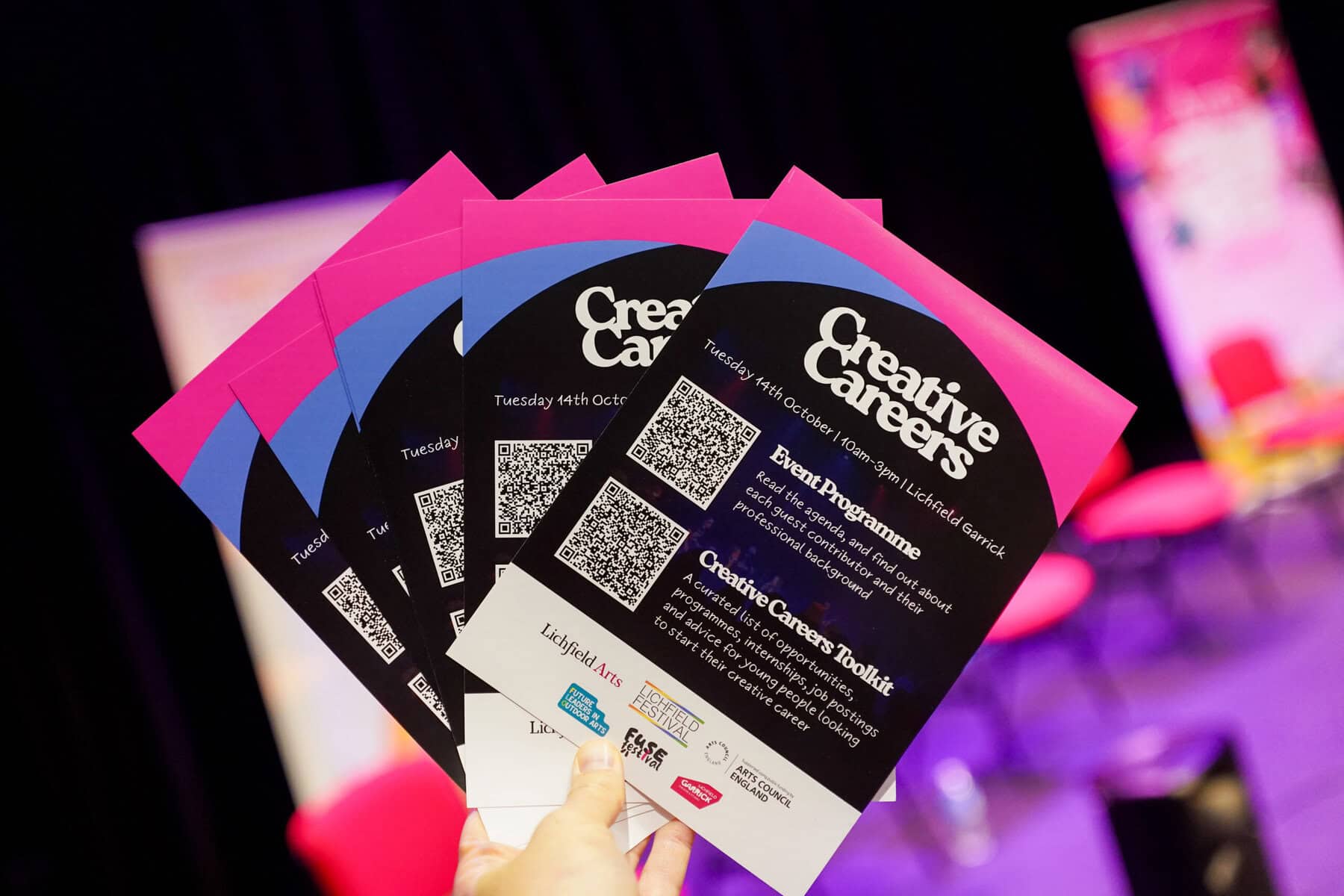 A handful of flyers for a creative careers day event