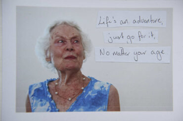 A photograph of a woman with the text 'life's an adventure, go for it no matter your age'
