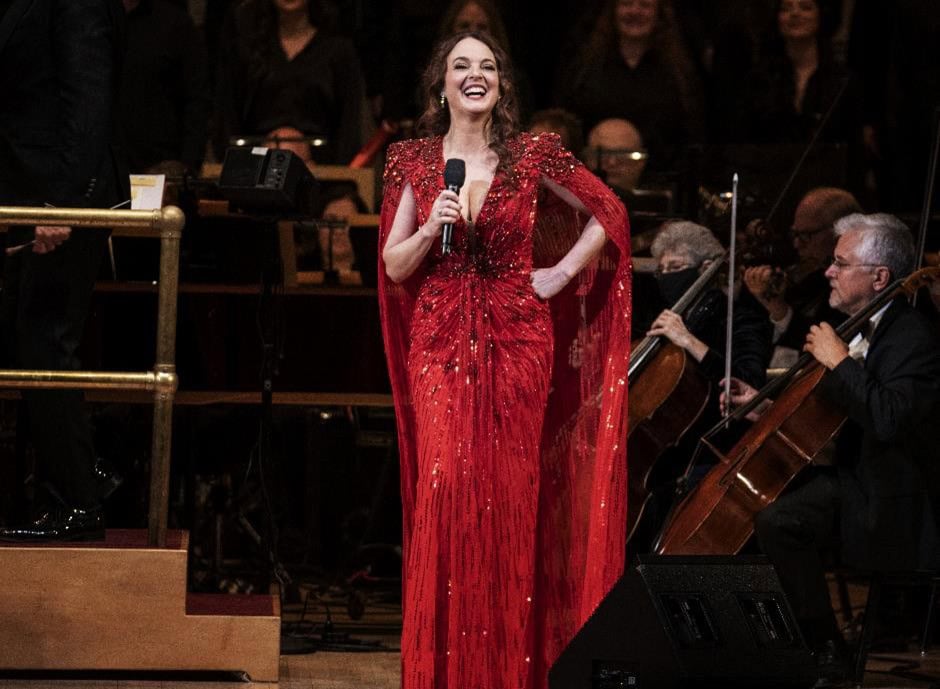 Melissa in red sequin dress with orchestra