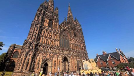 Lichfield Cathedral above a crowd