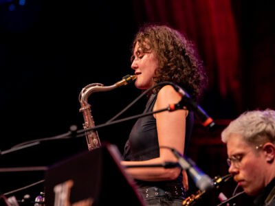 A saxophonist plays on stage